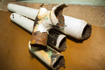 Pieces of an old sewer pipe. Apartment in a multi-storey residential building in the city. Several...