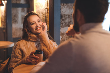Young couple drinking coffee in cafe