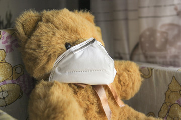 Coronavirus child: teddy bear with mask - 345417246