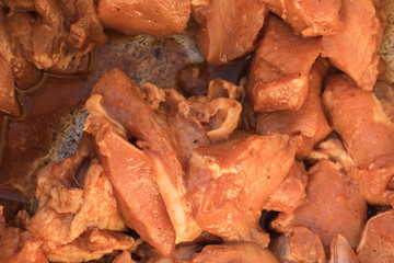 Pieces of raw pork in a sauce.