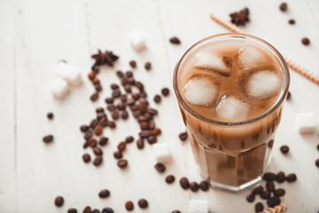 Glass of tasty iced coffee on table