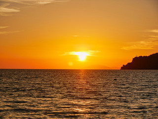 Fototapeta na wymiar Beautiful sunset over the sea with a very red sun in Malaysia