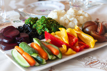 Soft focus. Dinner table. On a plate is a set of vegetables.