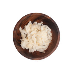 dried coconut in a brown wooden plate.