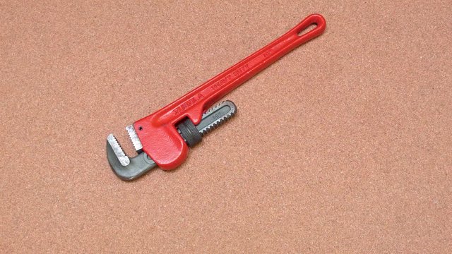 Holding red steel tool of a working surface
