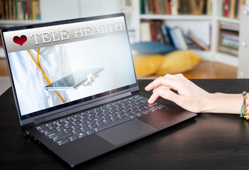 tele health concept doctor with tablet on a laptop screen