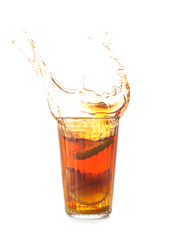 Glass of tasty cold ice tea with splash on white background