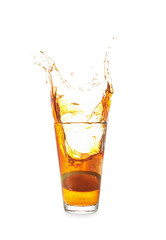 Glass of tasty cold ice tea with splash on white background