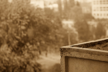 Horizontal frame. City landscape in the fall. In the frame, a concrete balcony against the backdrop of an autumn park. Photographed in Ukraine, Kiev region.
