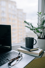 Workplace at home on the windowsill. Vertical photo.