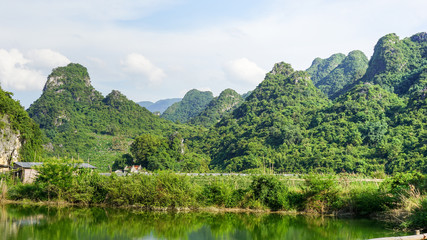 Naklejka na ściany i meble A beautiful landscape of green hills, mountains and river in YingDe, China