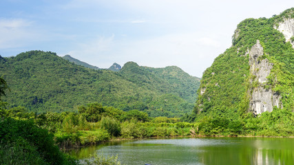 Fototapeta na wymiar A beautiful landscape of green hills, mountains and river in YingDe, China