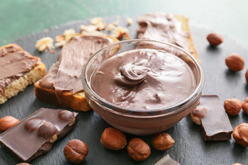 Fresh bread and chocolate paste on slate plate, closeup