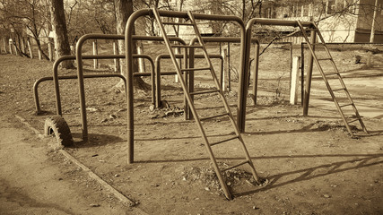Fototapeta na wymiar Sports field for children exercise. Horizontal frame. Picture taken in Ukraine, Kiev region. Black and white image. Sepia.
