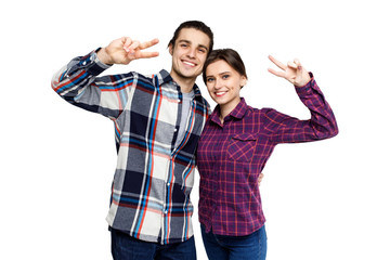 Happy young lovely couple having fun together and looking to camera  over white background