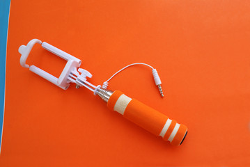 Selfie stick on a bright background, modern technology.