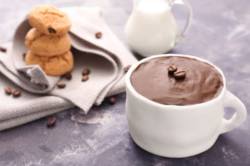 Chocolate cake in shape of coffee cup on dark background