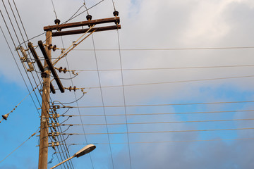 Electric wires wooden pole. Parallel and perpendicular lines.