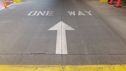 One way sign on the driveway in parking garage