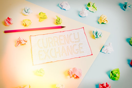 Conceptual hand writing showing Currency Exchange. Concept meaning Process of changing one currency into another ForEx Colored crumpled papers empty reminder blue yellow clothespin