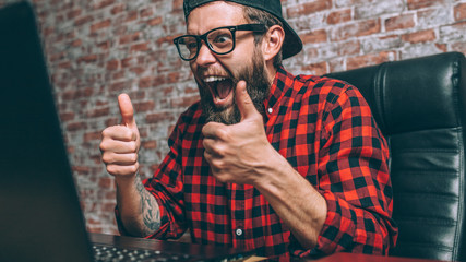 Young man having on-line video conferencing on laptop with different people, work remotely from home. Video conferencing, new app easy usage in all world.