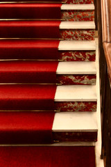 Stairway in fine italian marble with a prestigious red carpet