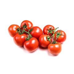 several fresh tomatoes with green leaves isolated on a white background. Juicy red tomatoes. Ripe vegetables. Organic product.