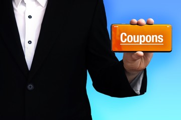 Coupons. Lawyer in a suit holds a smartphone at the camera. The term Coupons is on the phone. Concept for law, justice, judgement