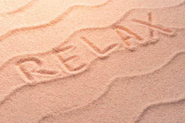 Plakat RELAX lettering on sand with wave and evening light. Minimal exotic vacation and travel concept, Flat lay top view copy space