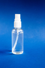 Hand picked alcohol sanitizer spray on black background. Hygiene and Virus Prevention Concept.