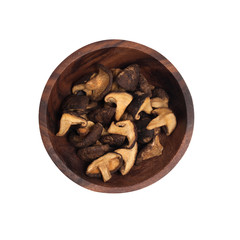 dried shiitake mushrooms in a brown wooden plate.