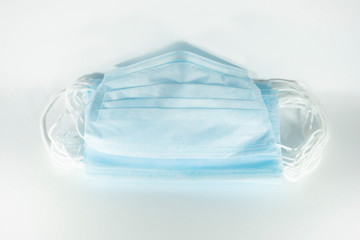 disposable blue medical mask on a white background