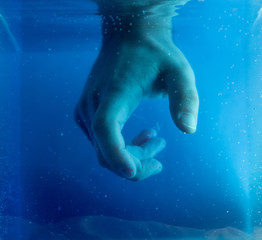 Fototapeta premium Artistic view of hand under colored water