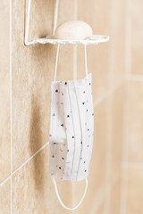 Surgical mask hangs in the bathroom, facial protection