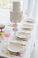 Birthday or wedding table setting in white colors with cocktails in glasses. Baby shower or girl party. Selective focus