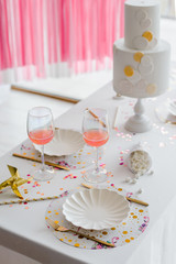 Fototapeta na wymiar Birthday or wedding table setting in white colors with cocktails in glasses. Baby shower or girl party. Selective focus