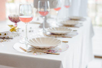 Birthday or wedding table setting in white colors with cocktails in glasses. Baby shower or girl party. Selective focus