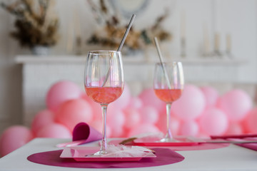 Cocktail in glasses . Elegant festive table setting in bright tones . Wedding, birthday, baby shower, girl party decoration.