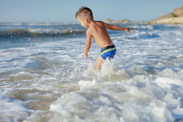 a child jumps in the waves