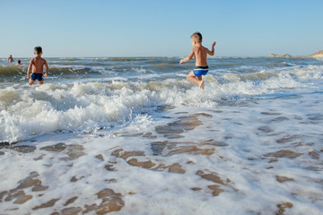 a child jumps in the waves