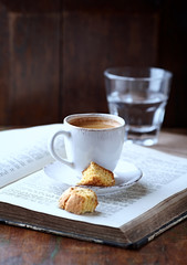 Cup of coffee with cantuccini  (Italian cookies) on rustic wooden background. 