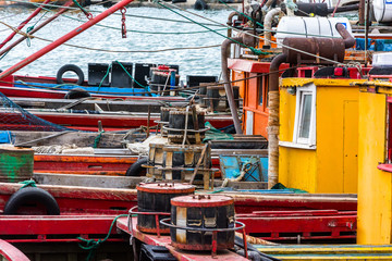 Fototapeta na wymiar small colored fishing boats moored in the harbor