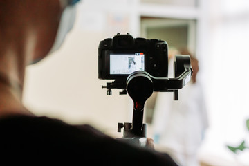 Videographer recording video on the site with mirrorless camera using gimbal
