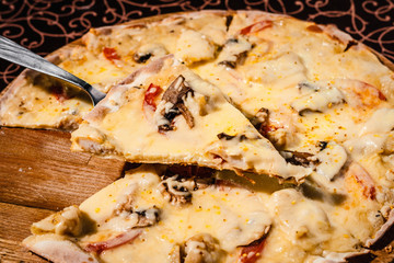 Pizza with cheese, mushrooms and sausage.