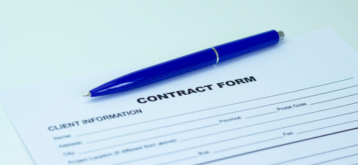 Blue ballpoint pen on contract papers. Lettering contract on paper.
