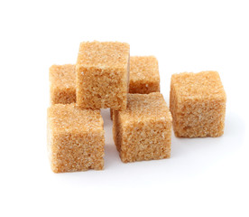 Cane sugar isolated on a white background. Cubes of cane sugar. Brown sugar