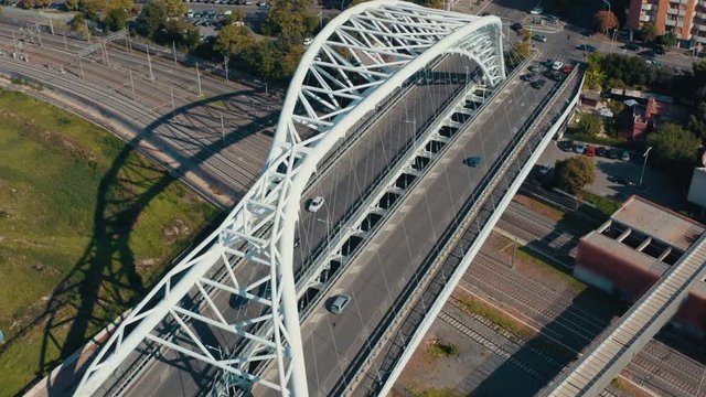 Aerial view of modern European city bridge road with moving cars. Urban transportation concept, drone footage
