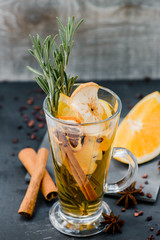 mulled white wine wirh spices on dark stone background