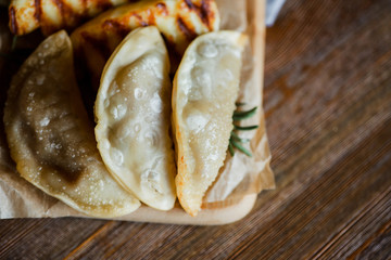 dumplings with rosemary on a wooden cutting board on wooden table