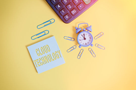 Text sign showing Cloud Technology. Business photo text storing and accessing data and programs over Internet Metal retro alarm clock wakeup clips calculator notepad colored background